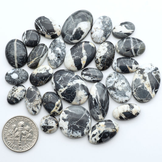Natural White Buffalo Stone Cabochons are semi-precious gemstones cut into shapes ideal for jewelry-making, making them an excellent choice for artisans.