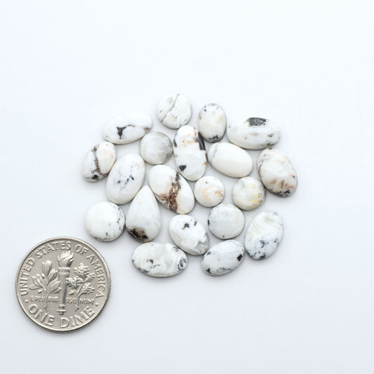 Natural White Buffalo Stone Cabochons are semi-precious gemstones cut into shapes ideal for jewelry-making, making them an excellent choice for artisans.