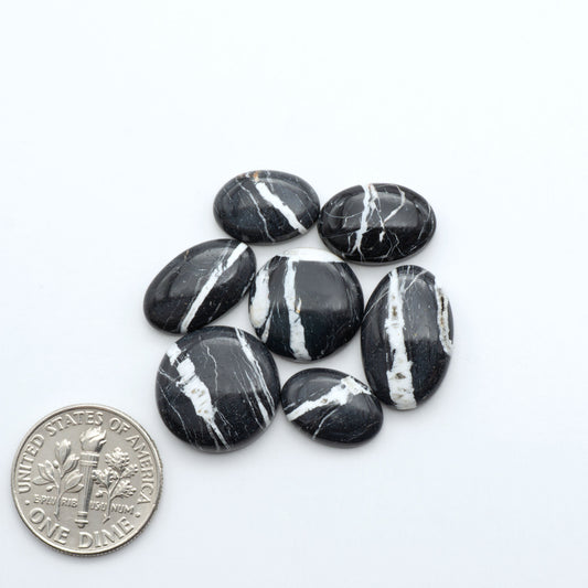 Natural White Buffalo Stone Cabochons are semi-precious gemstones cut into shapes ideal for jewelry-making, making them an excellent choice for artisans.