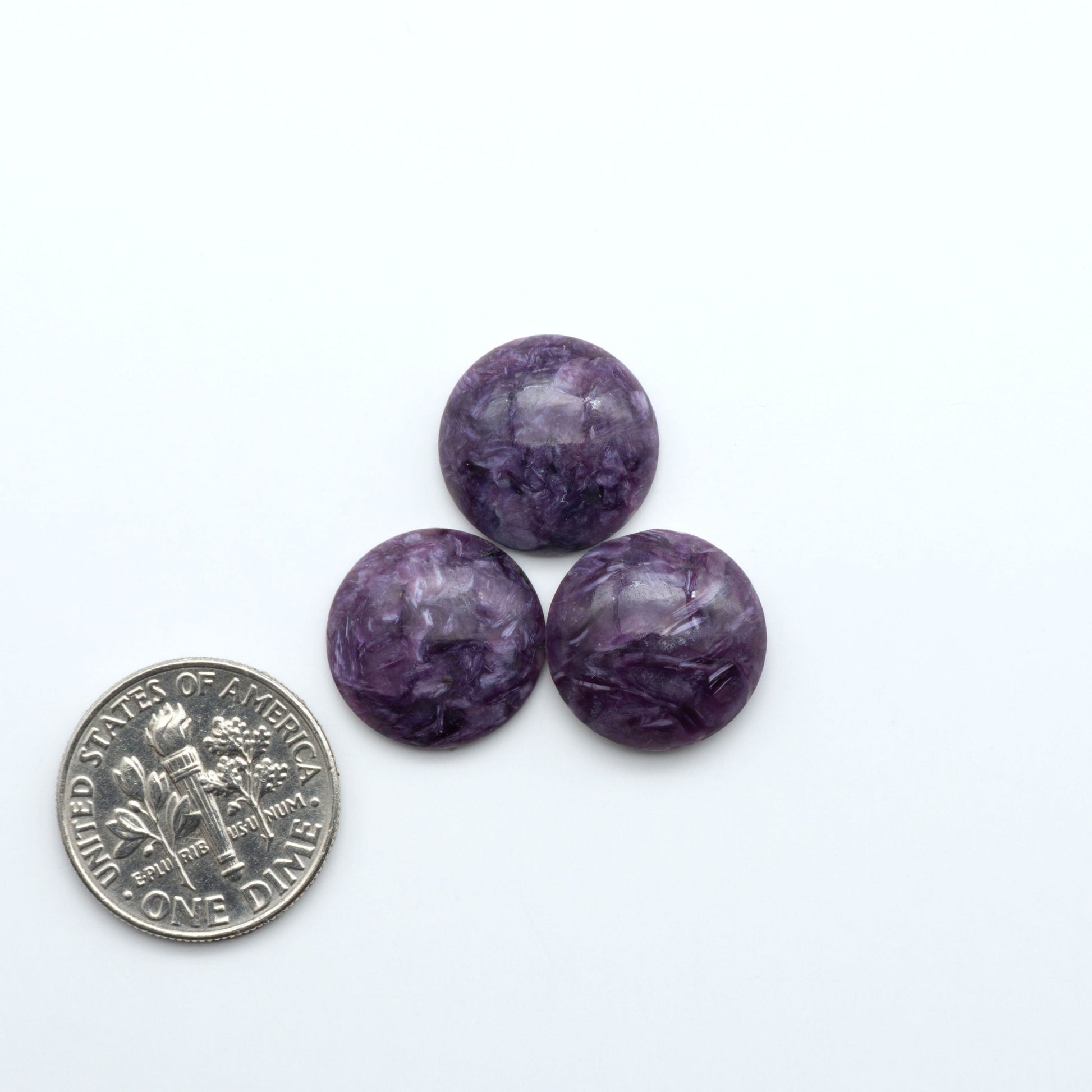 Shop natural Charoite cabochons with vivid violet swirls, perfect for jewelry makers and silversmiths creating rings, pendants, and custom designs.