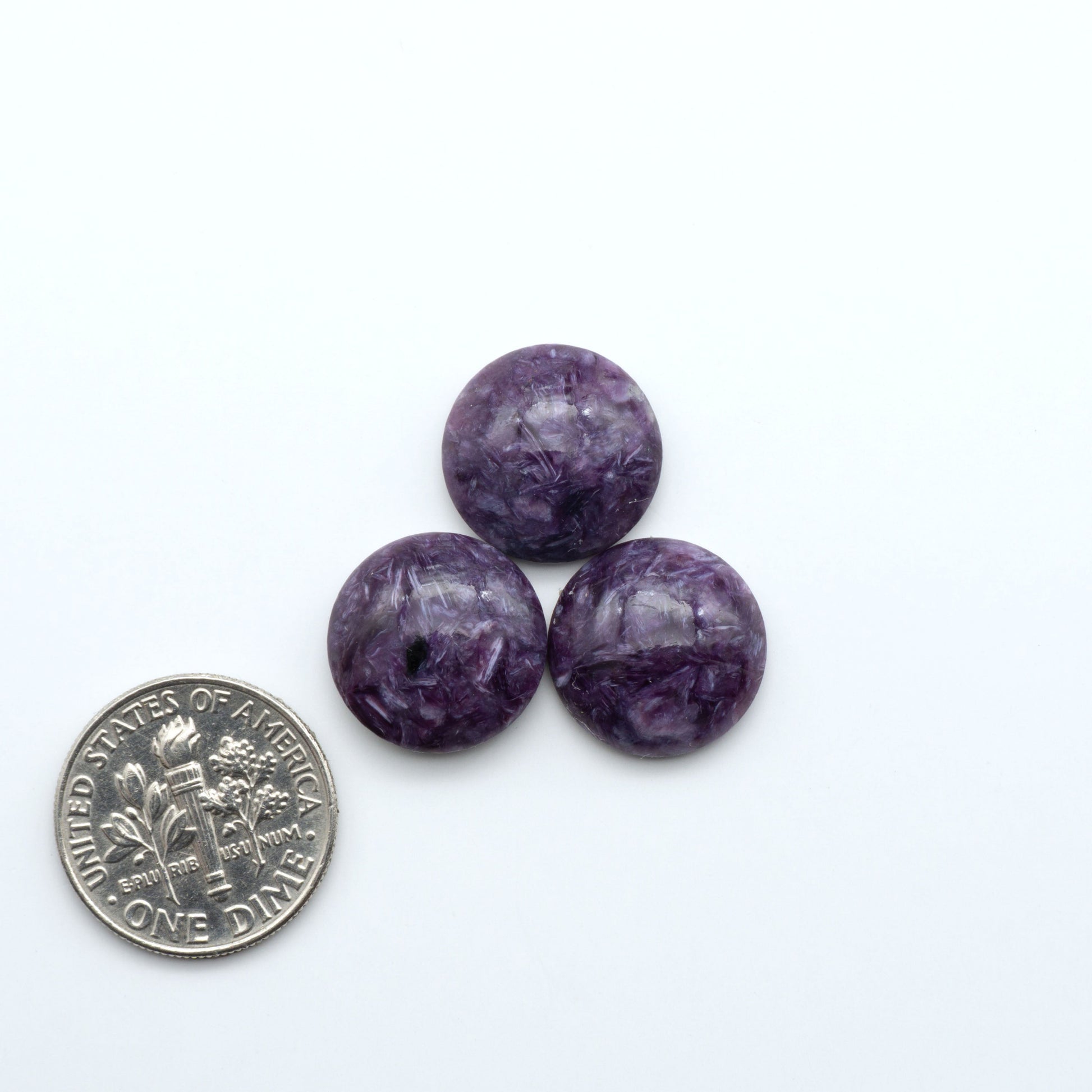 Shop natural Charoite cabochons with vivid violet swirls, perfect for jewelry makers and silversmiths creating rings, pendants, and custom designs.
