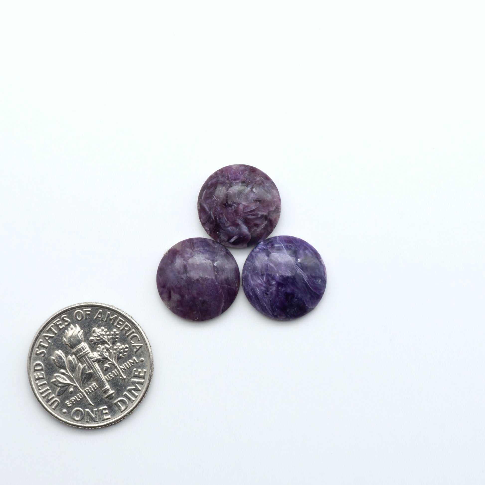 Shop natural Charoite cabochons with vivid violet swirls, perfect for jewelry makers and silversmiths creating rings, pendants, and custom designs.