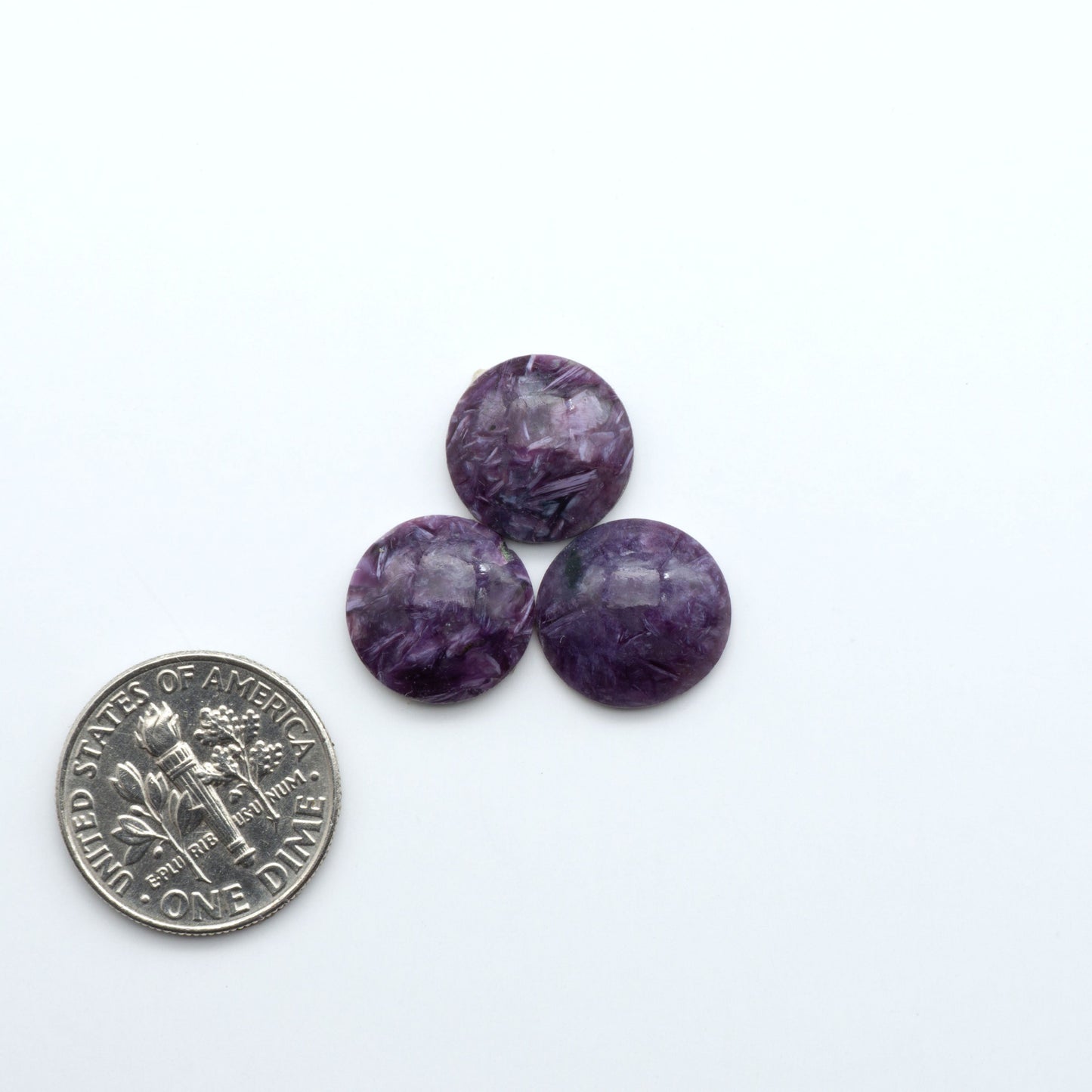 Shop natural Charoite cabochons with vivid violet swirls, perfect for jewelry makers and silversmiths creating rings, pendants, and custom designs.