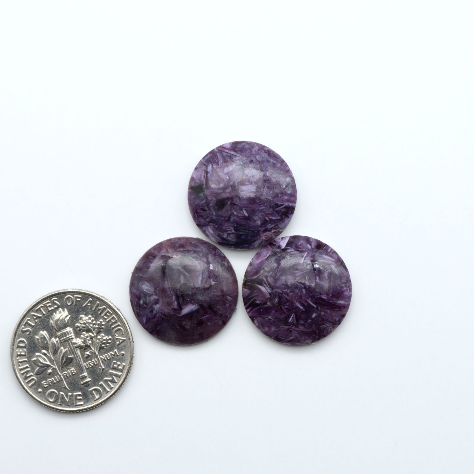 Shop natural Charoite cabochons with vivid violet swirls, perfect for jewelry makers and silversmiths creating rings, pendants, and custom designs.
