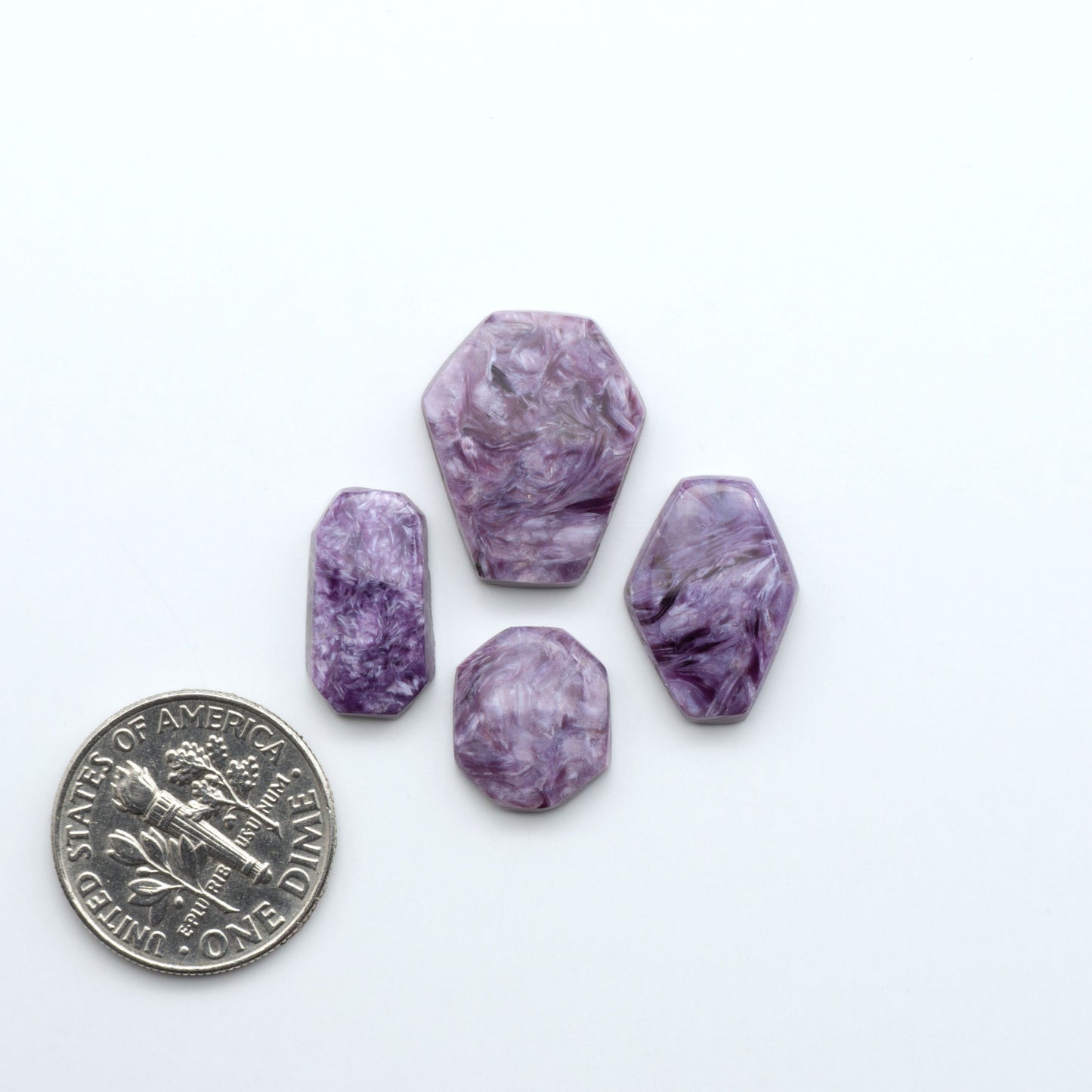 Shop natural Charoite cabochons with vivid violet swirls, perfect for jewelry makers and silversmiths creating rings, pendants, and custom designs.
