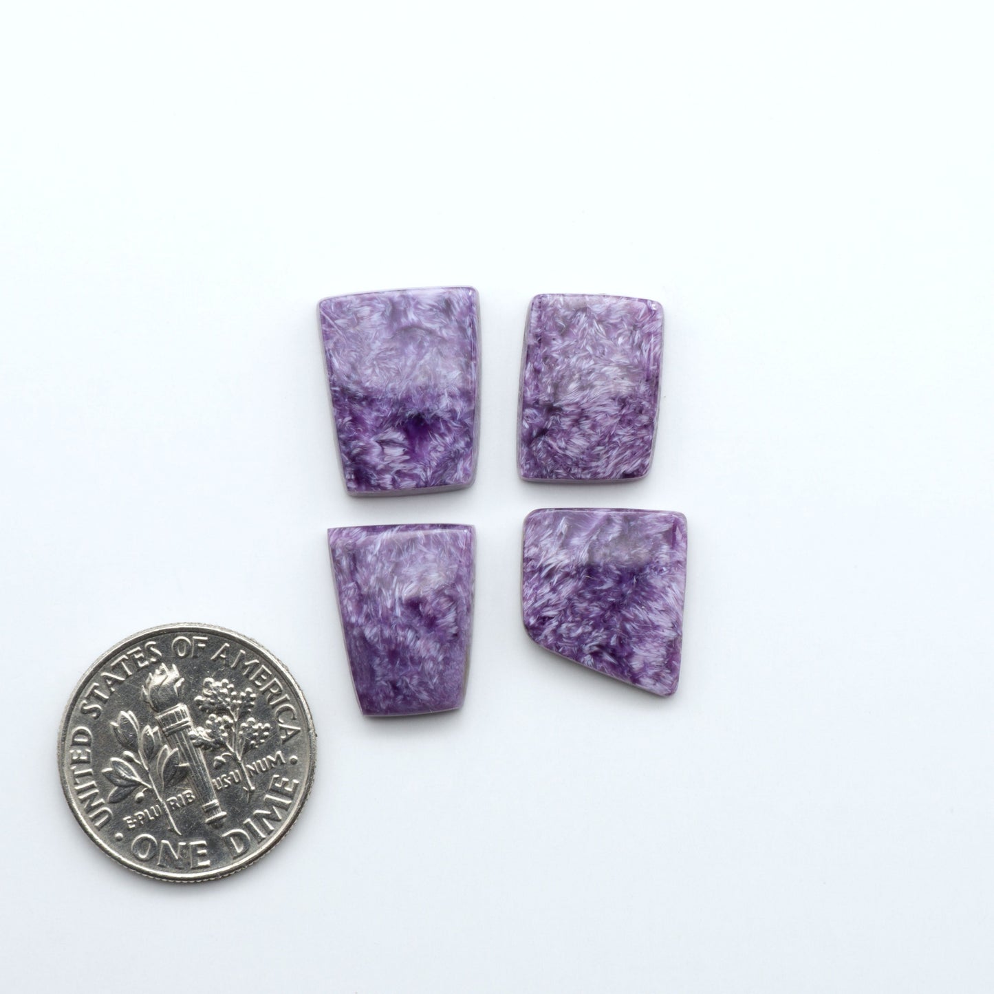 Shop natural Charoite cabochons with vivid violet swirls, perfect for jewelry makers and silversmiths creating rings, pendants, and custom designs.