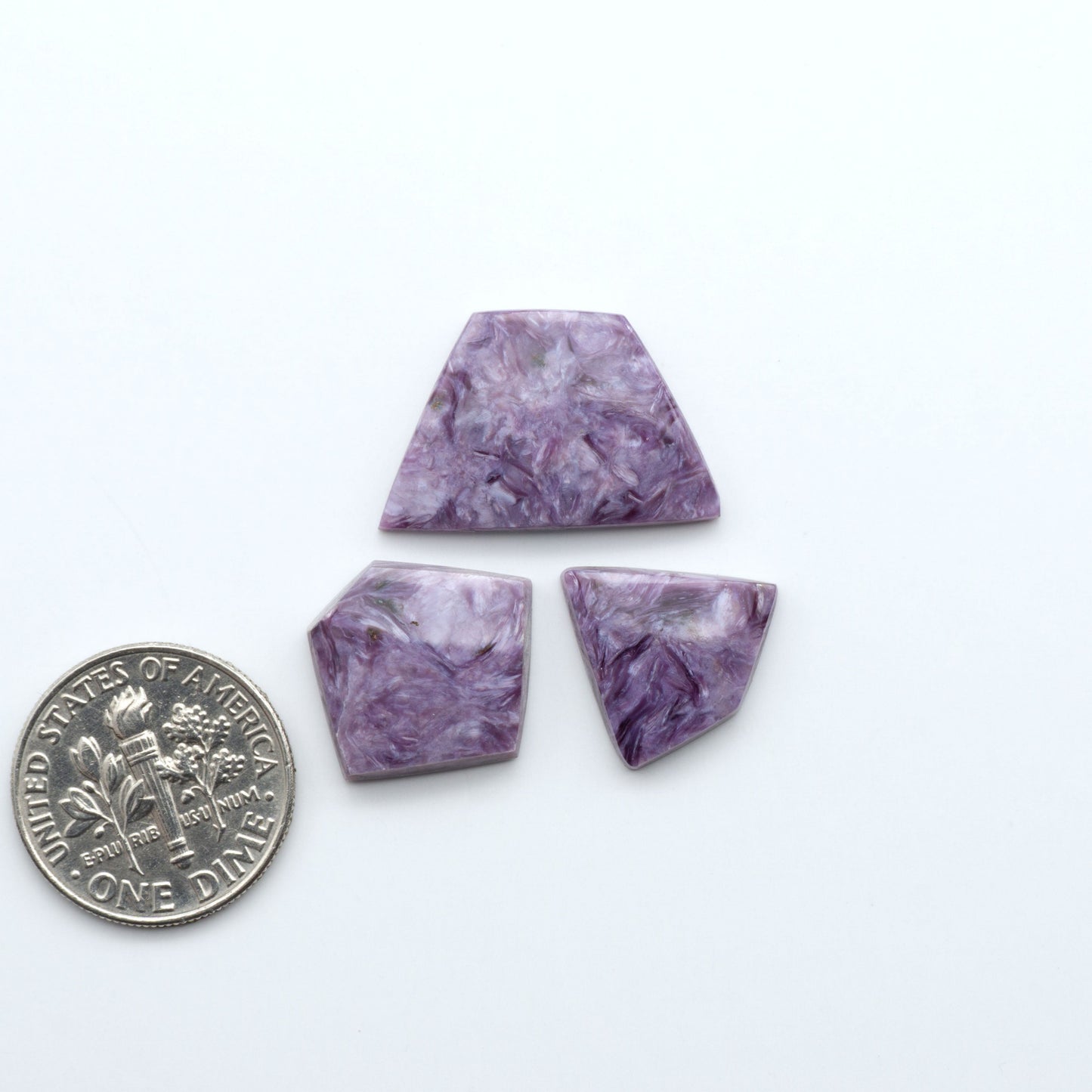 Shop natural Charoite cabochons with vivid violet swirls, perfect for jewelry makers and silversmiths creating rings, pendants, and custom designs.