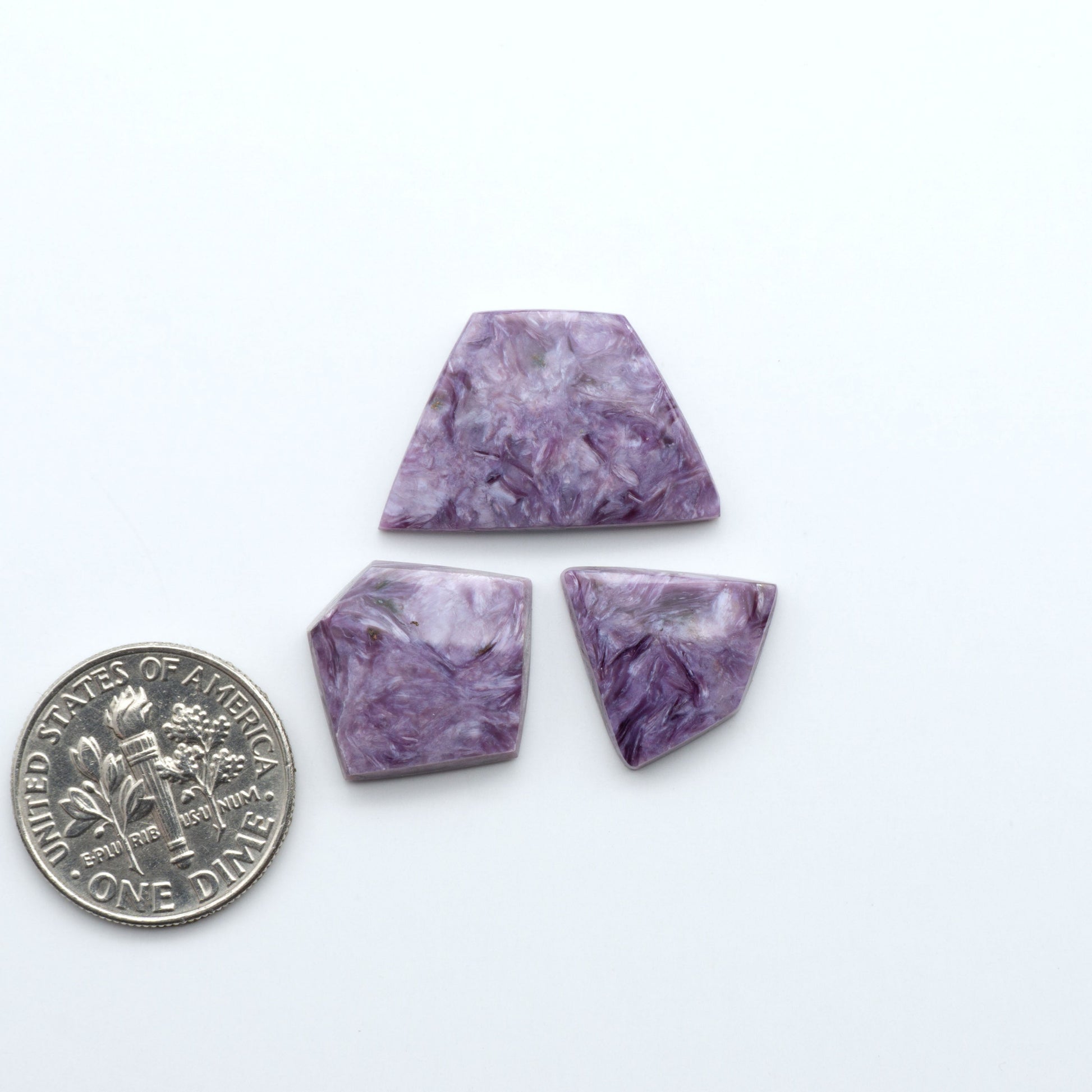 Shop natural Charoite cabochons with vivid violet swirls, perfect for jewelry makers and silversmiths creating rings, pendants, and custom designs.