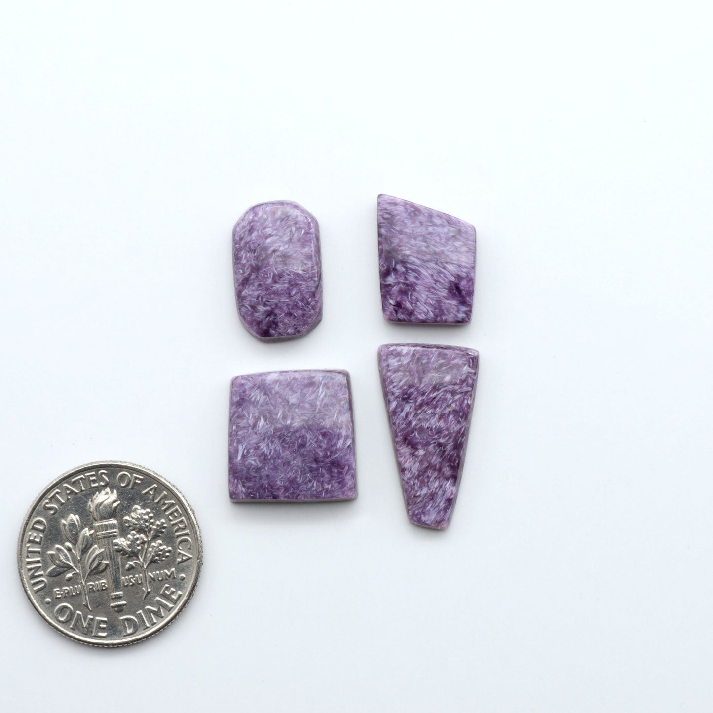 Shop natural Charoite cabochons with vivid violet swirls, perfect for jewelry makers and silversmiths creating rings, pendants, and custom designs.