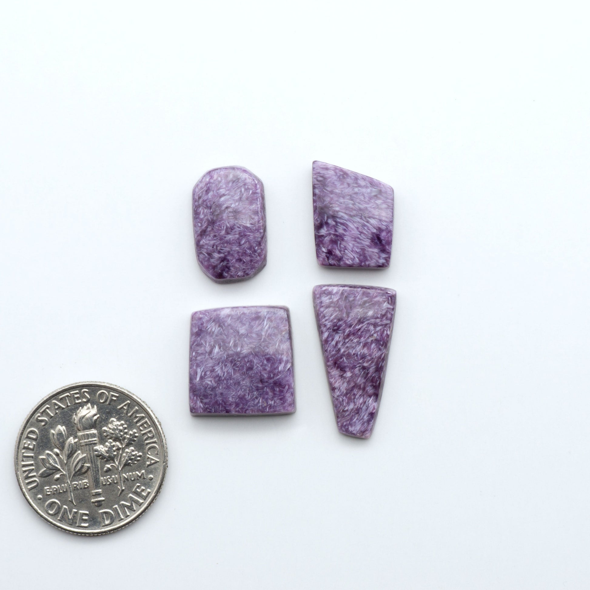 Shop natural Charoite cabochons with vivid violet swirls, perfect for jewelry makers and silversmiths creating rings, pendants, and custom designs.