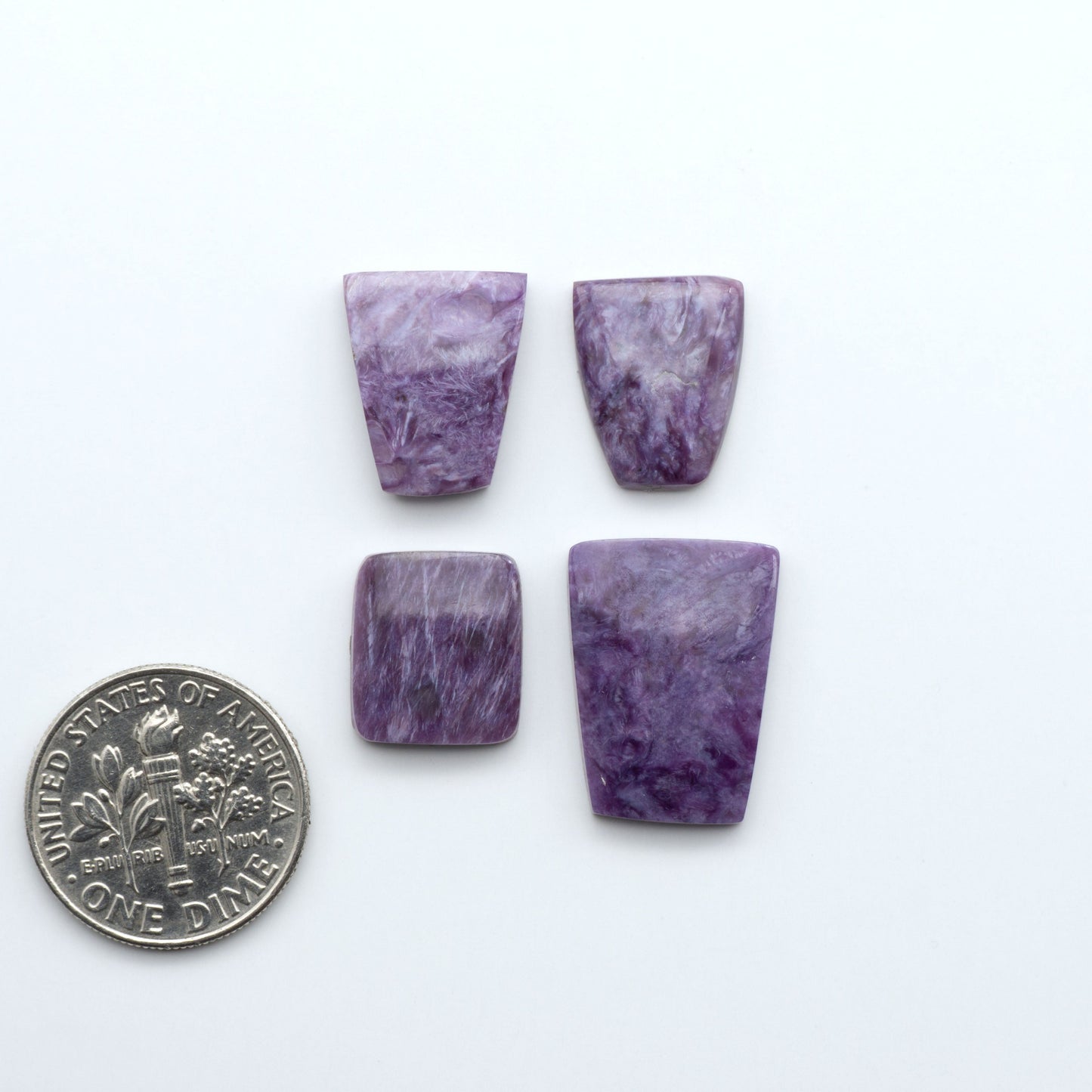 Shop natural Charoite cabochons with vivid violet swirls, perfect for jewelry makers and silversmiths creating rings, pendants, and custom designs.