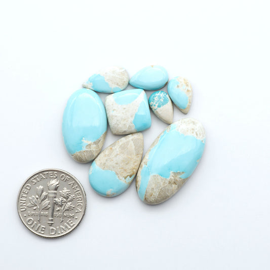 Royston Turquoise cabochons are famous for their distinctive matrix and unique green and blue hues, making them a favored option among jewelry designers.