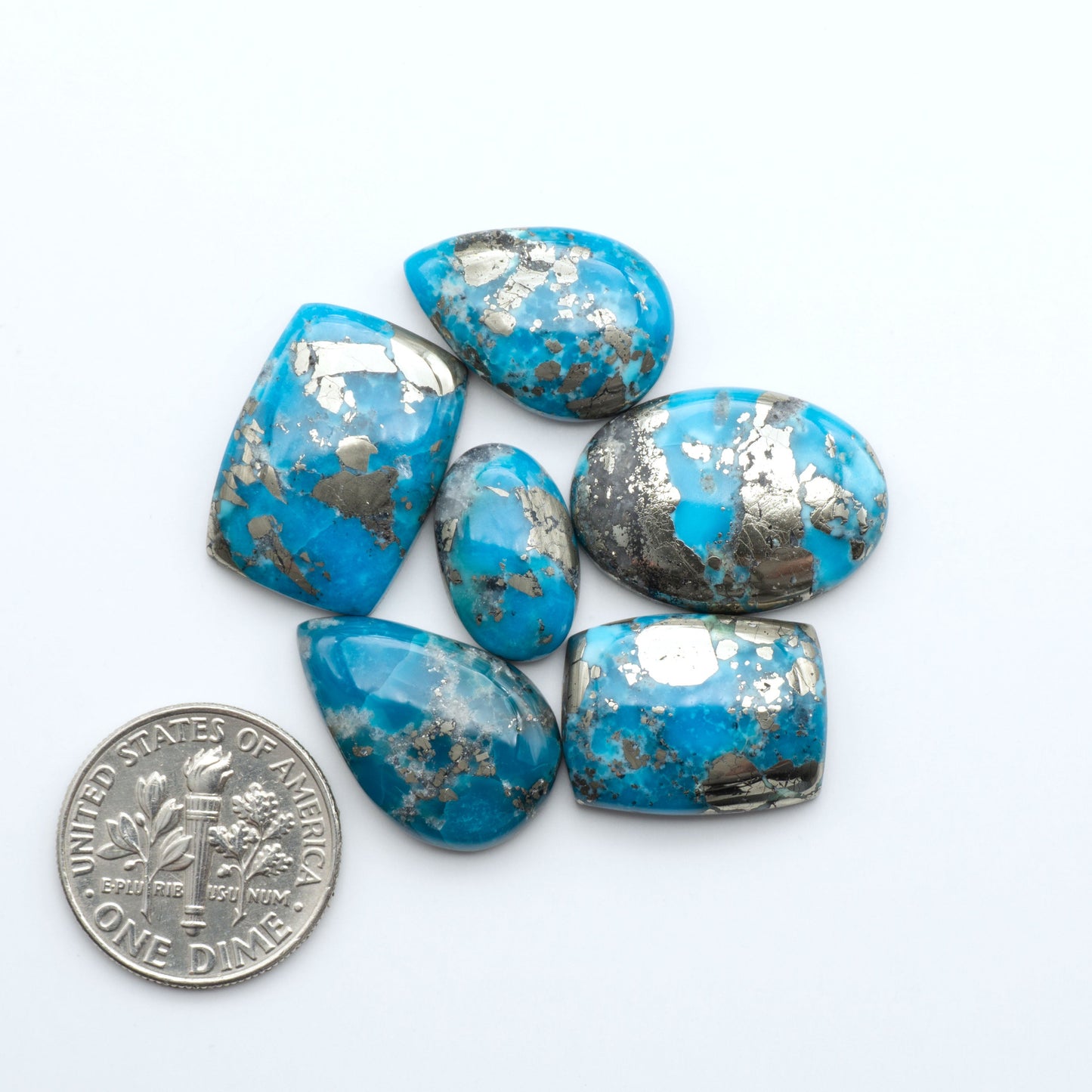 Nacozari turquoise cabochons are striking gemstones known for their vibrant blue to greenish-blue colors and pyrite, these stones are prized in jewelry making.