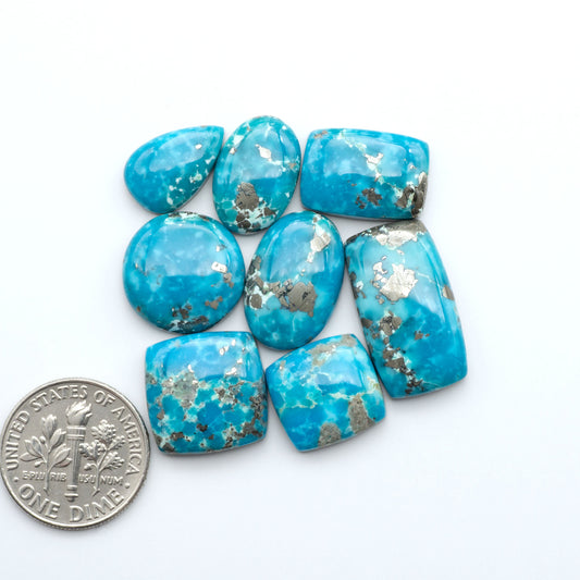Nacozari turquoise cabochons are striking gemstones known for their vibrant blue to greenish-blue colors and pyrite, these stones are prized in jewelry making.