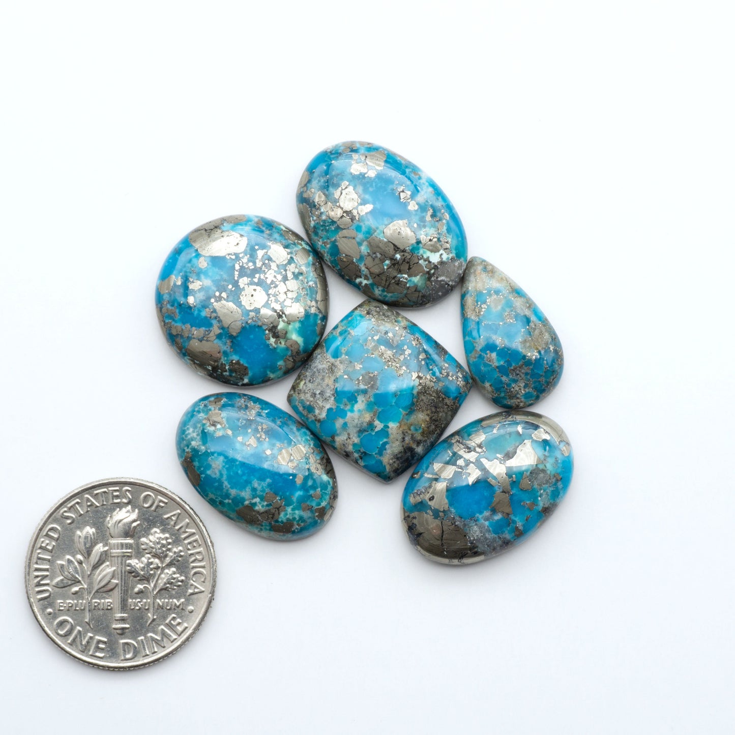 Nacozari turquoise cabochons are striking gemstones known for their vibrant blue to greenish-blue colors and pyrite, these stones are prized in jewelry making.