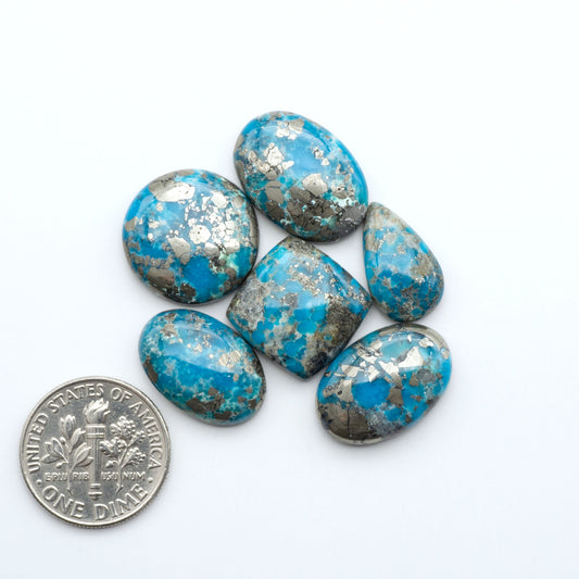 Nacozari turquoise cabochons are striking gemstones known for their vibrant blue to greenish-blue colors and pyrite, these stones are prized in jewelry making.