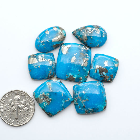 Nacozari turquoise cabochons are striking gemstones known for their vibrant blue to greenish-blue colors and pyrite, these stones are prized in jewelry making.