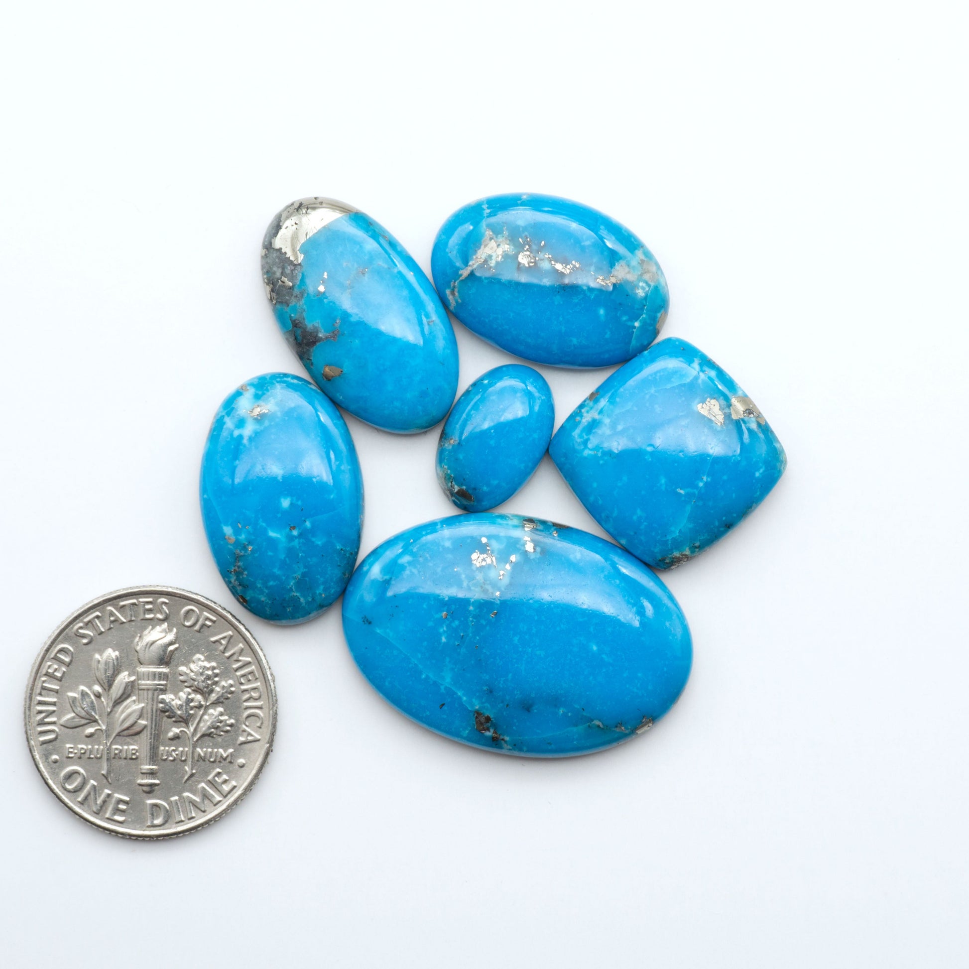 Nacozari turquoise cabochons are striking gemstones known for their vibrant blue to greenish-blue colors and pyrite, these stones are prized in jewelry making.