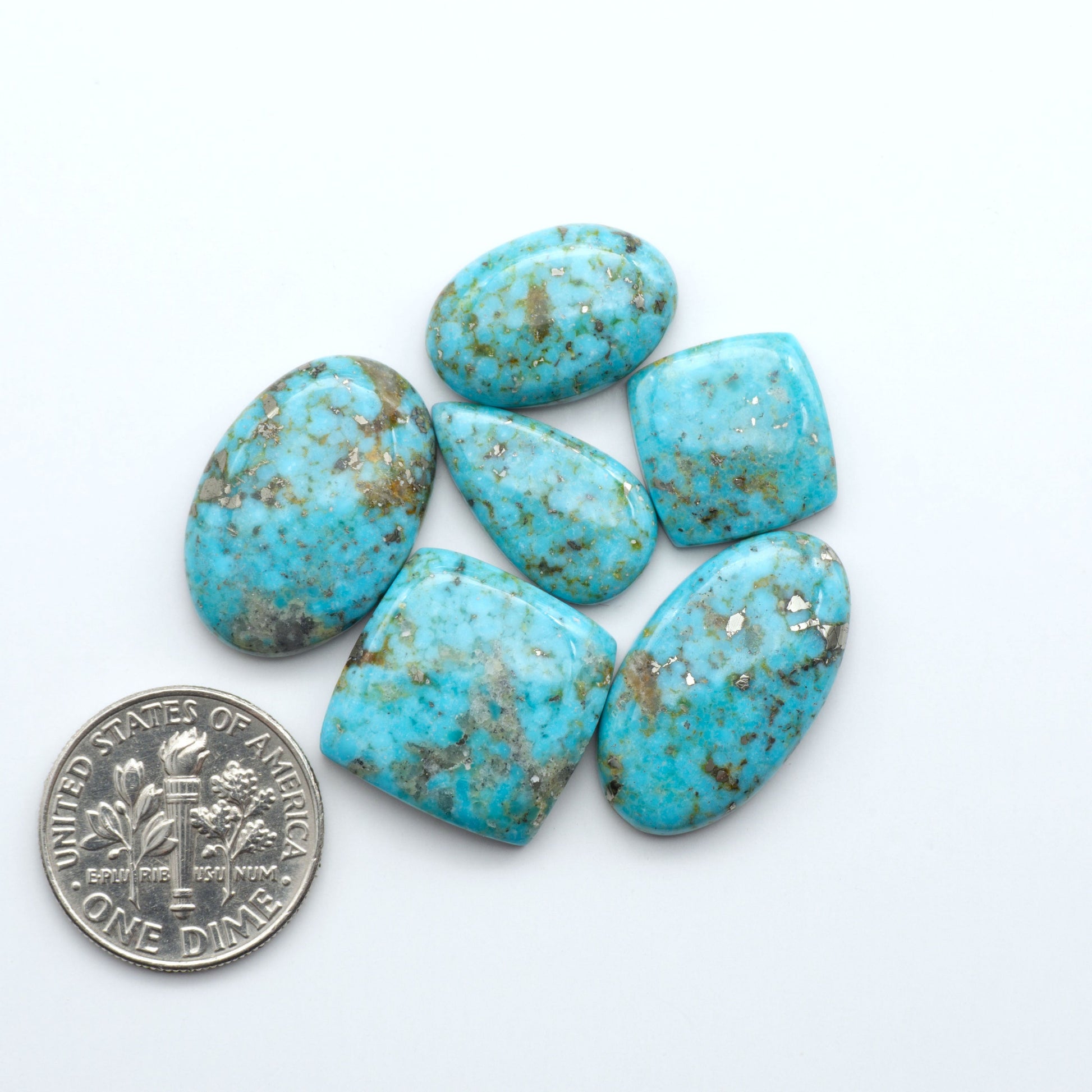 Nacozari turquoise cabochons are striking gemstones known for their vibrant blue to greenish-blue colors and pyrite, these stones are prized in jewelry making.