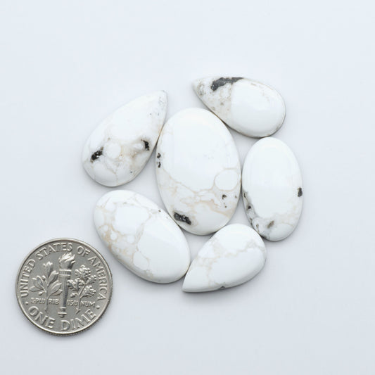 Natural White Buffalo Stone Cabochons are semi-precious gemstones cut into shapes ideal for jewelry-making, making them an excellent choice for artisans.

