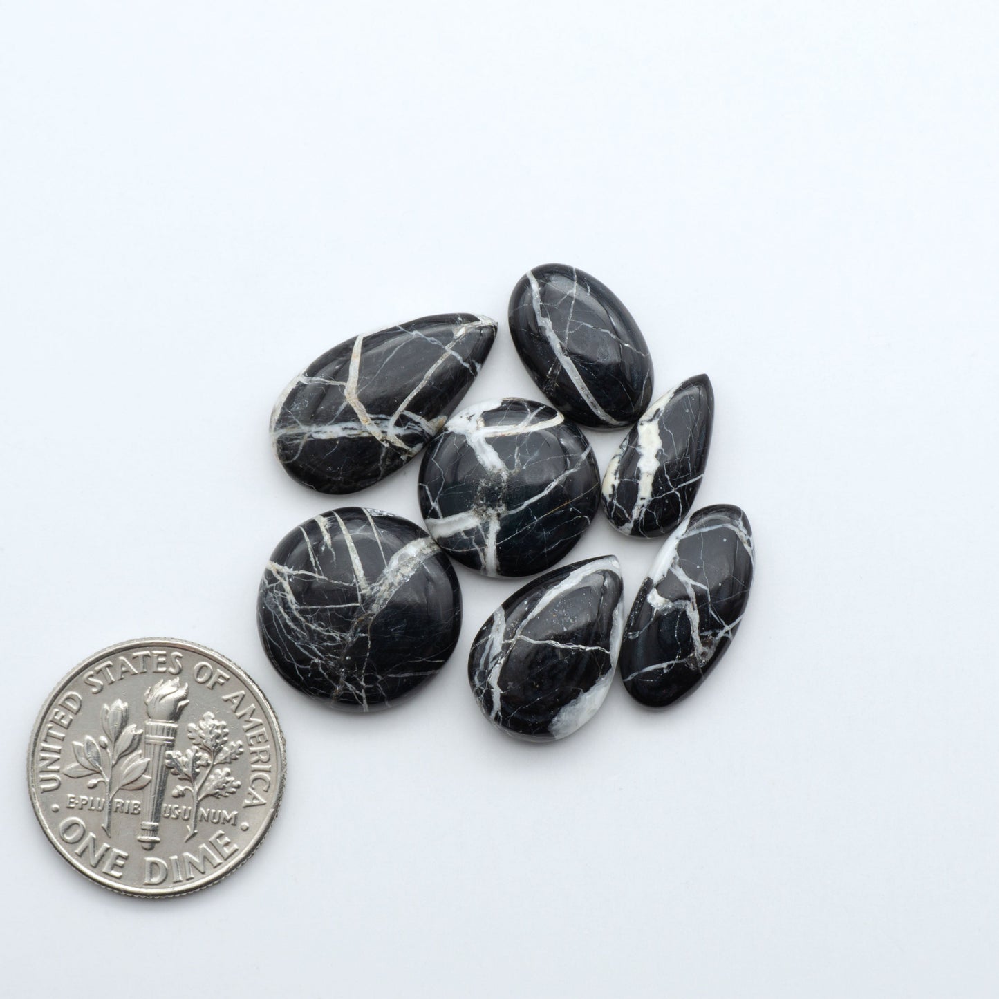 Natural White Buffalo Stone Cabochons are semi-precious gemstones cut into shapes ideal for jewelry-making, making them an excellent choice for artisans.

