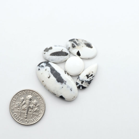 Natural White Buffalo Stone Cabochons are semi-precious gemstones cut into shapes ideal for jewelry-making, making them an excellent choice for artisans.
