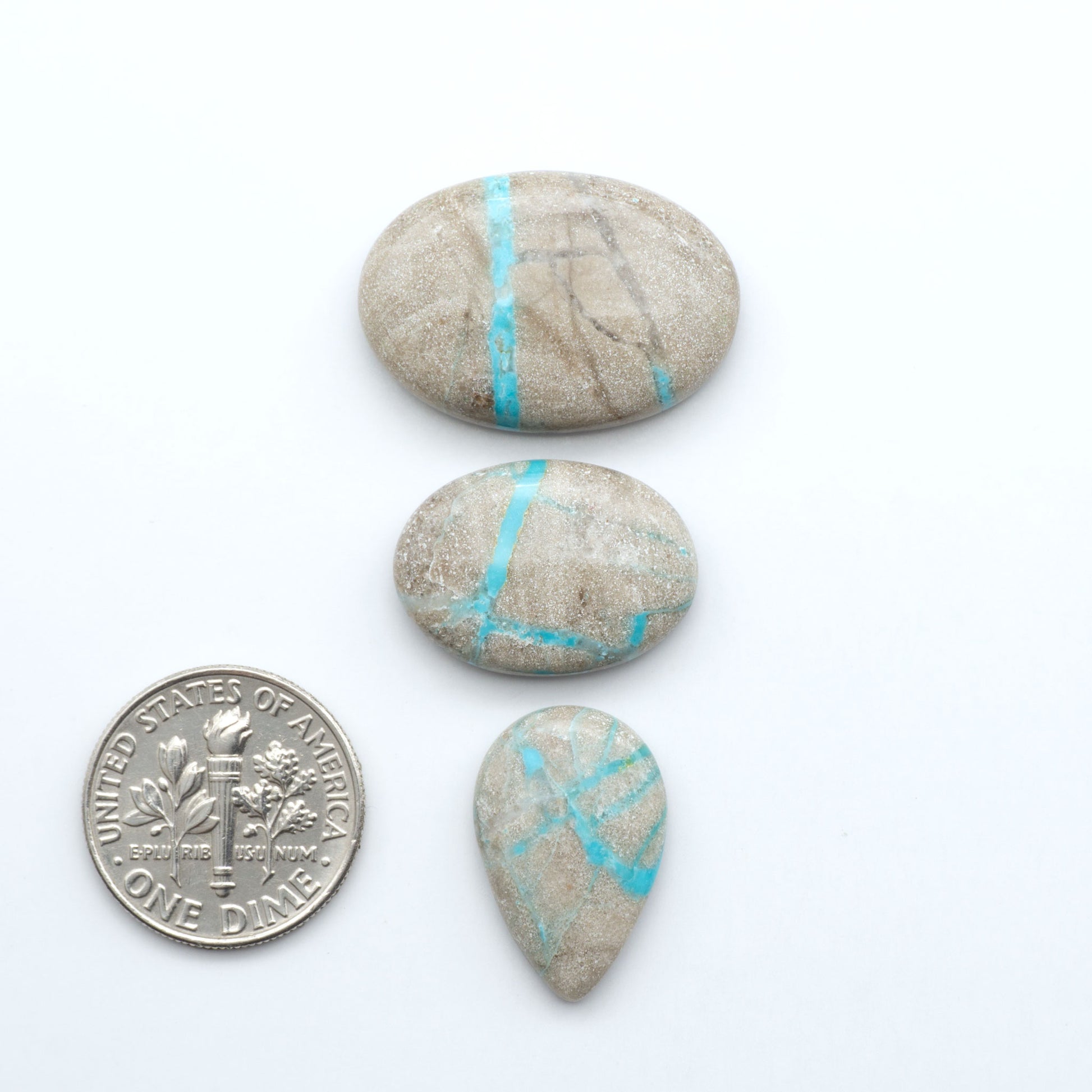 Carico Lake Turquoise cabochons with vibrant aqua-blue to turquoise tones and natural matrix, ideal for rings, pendants, and artisan jewelry.