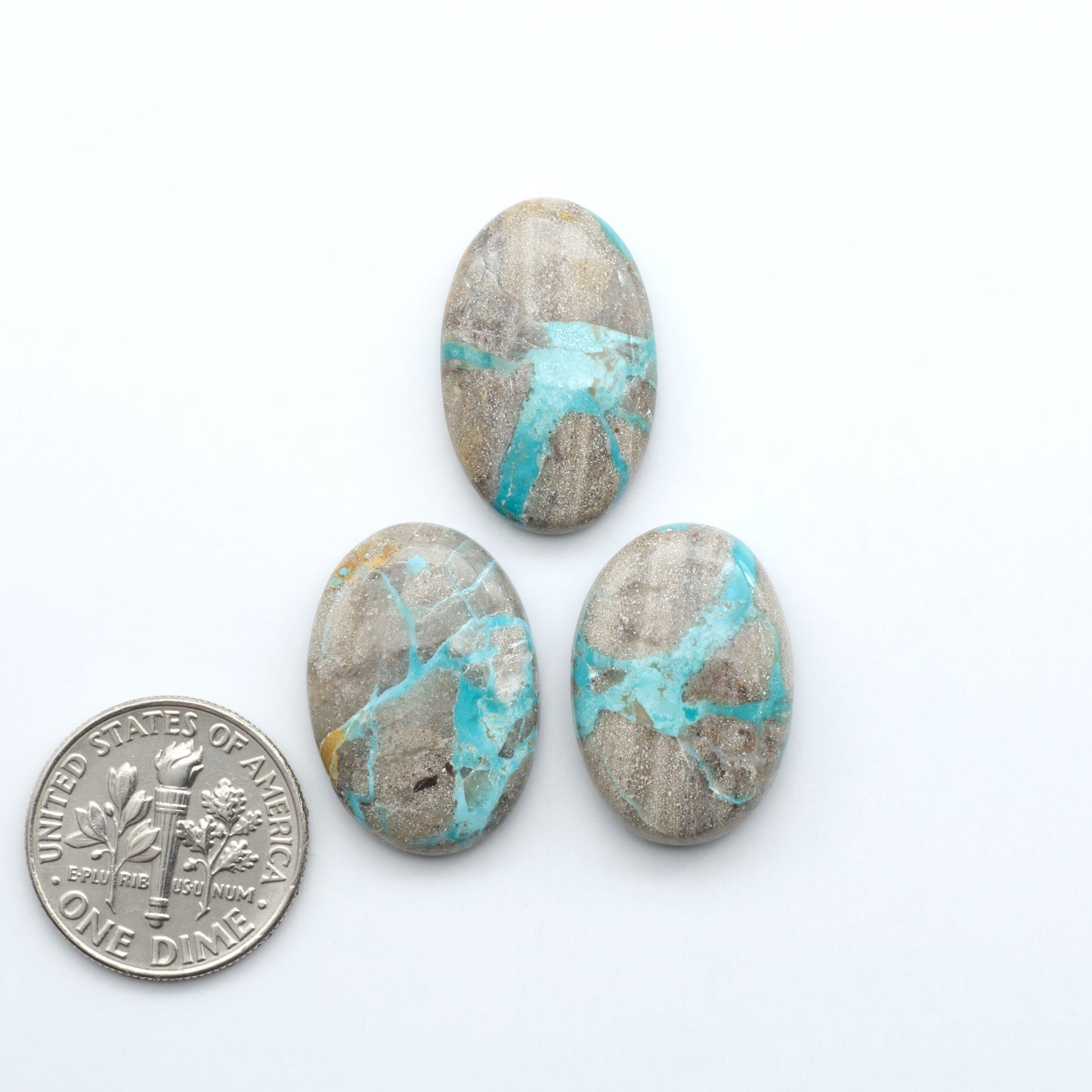 Carico Lake Turquoise cabochons with vibrant aqua-blue to turquoise tones and natural matrix, ideal for rings, pendants, and artisan jewelry.