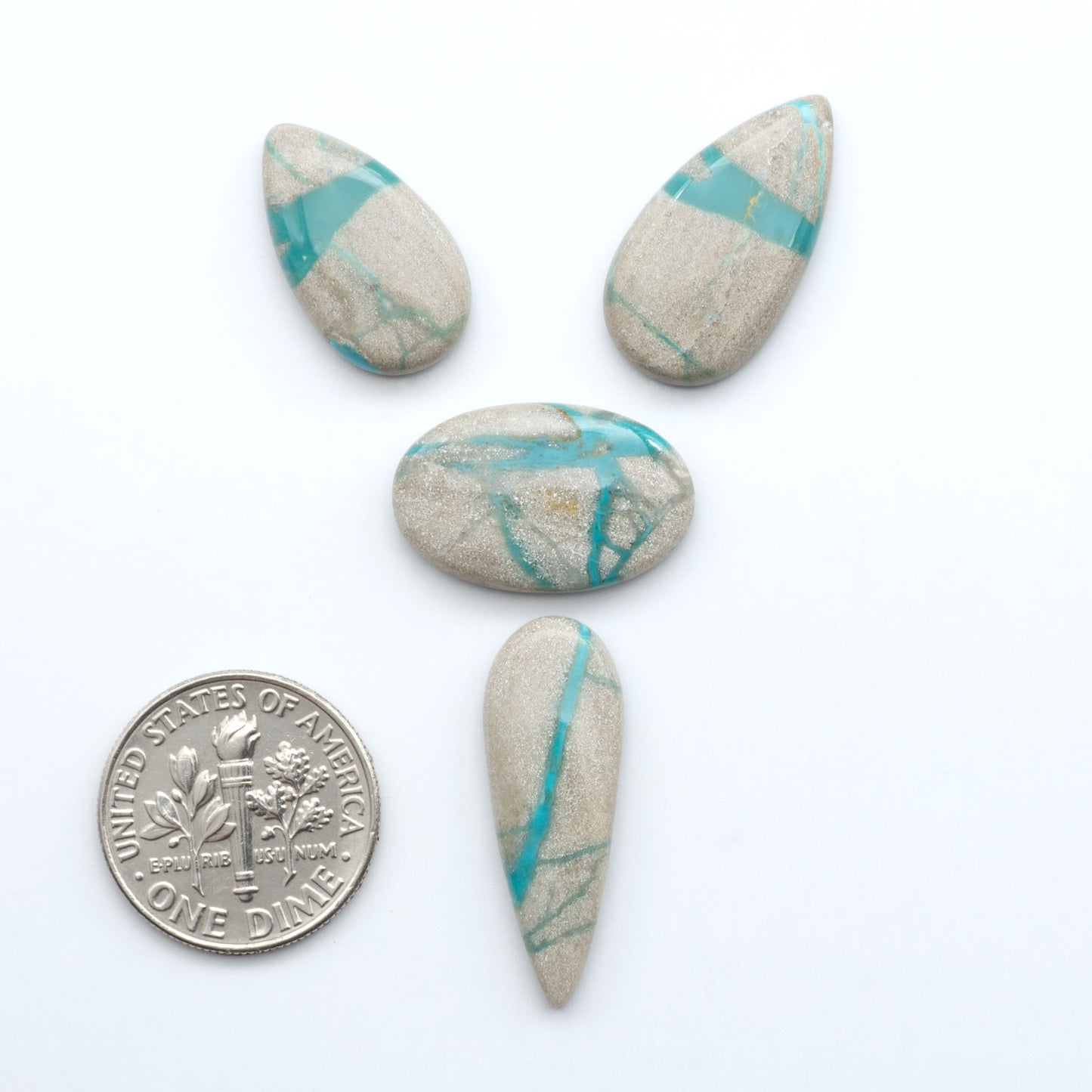 Carico Lake Turquoise cabochons with vibrant aqua-blue to turquoise tones and natural matrix, ideal for rings, pendants, and artisan jewelry.