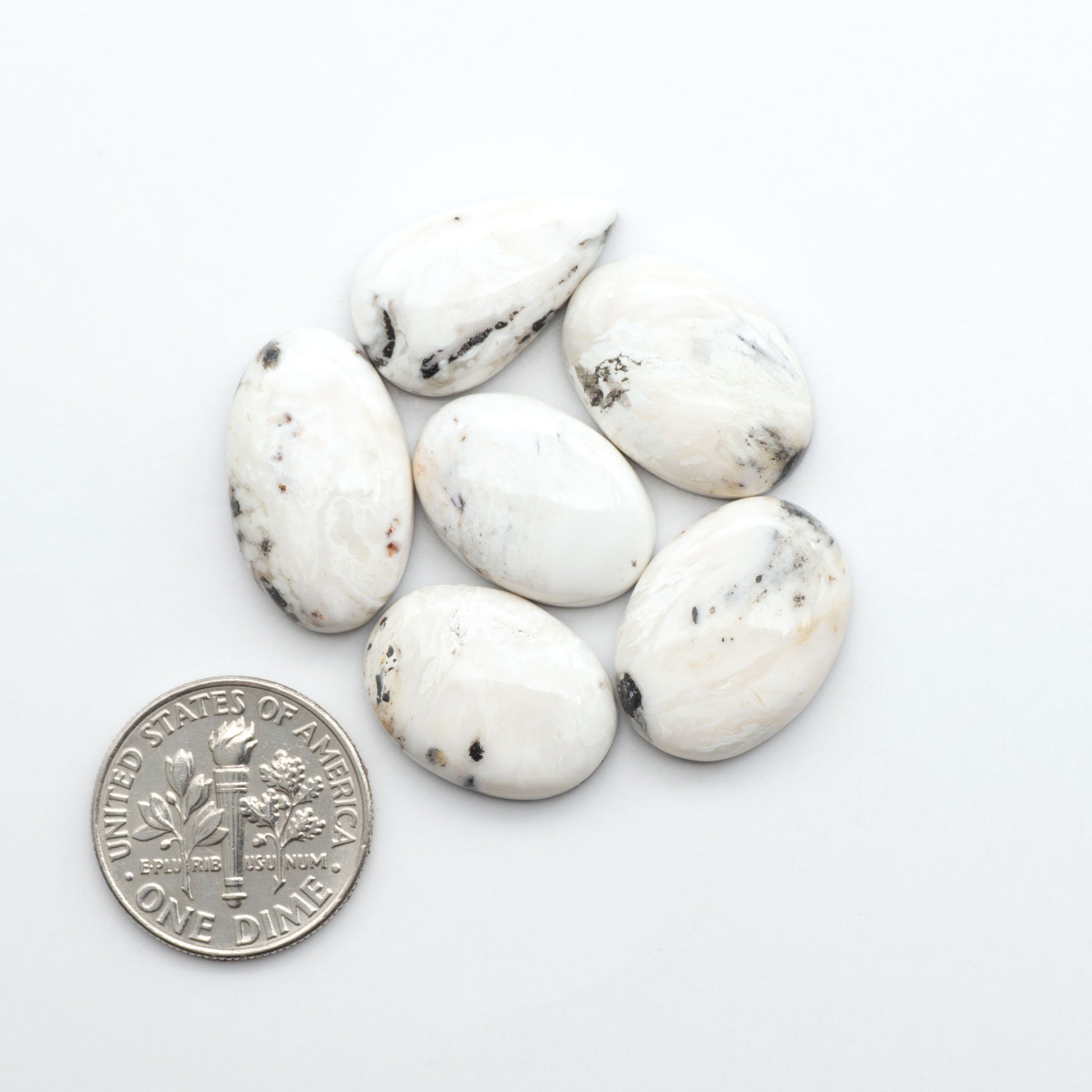 Natural White Buffalo Stone Cabochons are semi-precious gemstones cut into shapes ideal for jewelry-making, making them an excellent choice for artisans.