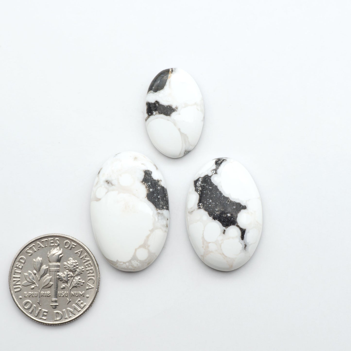Natural White Buffalo Stone Cabochons are semi-precious gemstones cut into shapes ideal for jewelry-making, making them an excellent choice for artisans.