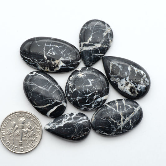 Natural White Buffalo Stone Cabochons are semi-precious gemstones cut into shapes ideal for jewelry-making, making them an excellent choice for artisans.