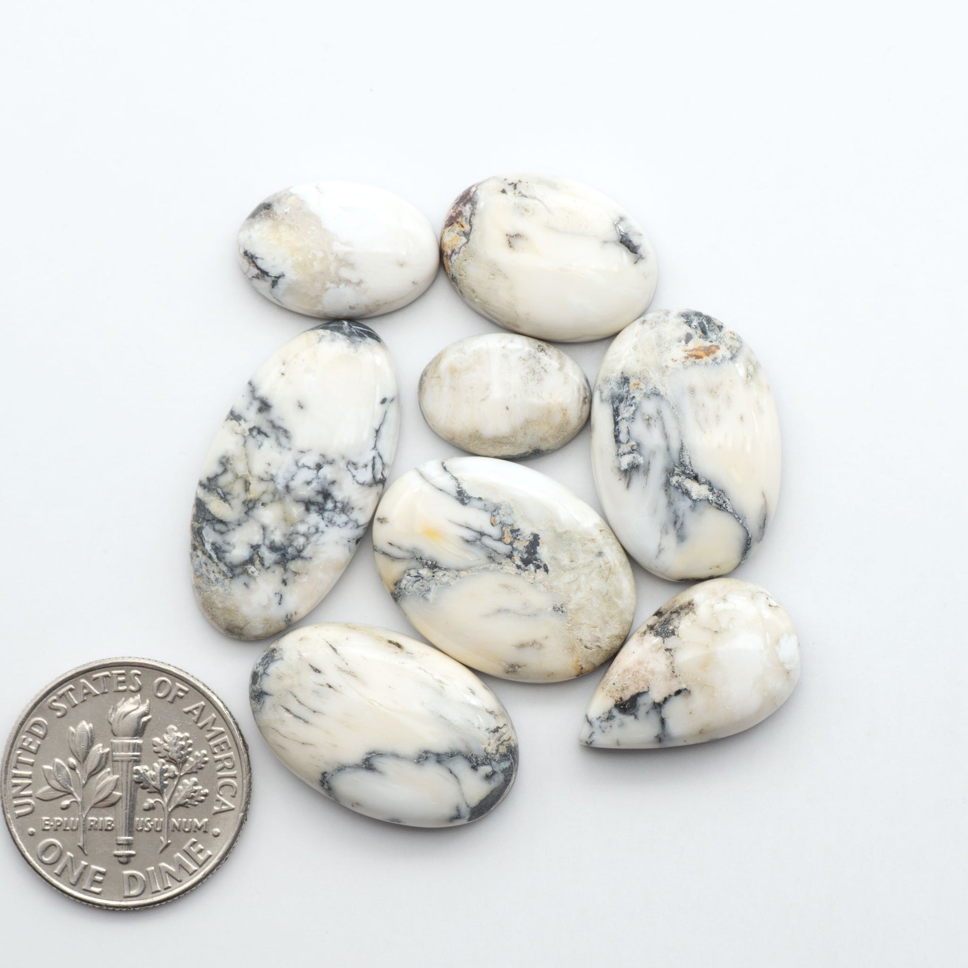Natural White Buffalo Stone Cabochons are semi-precious gemstones cut into shapes ideal for jewelry-making, making them an excellent choice for artisans.