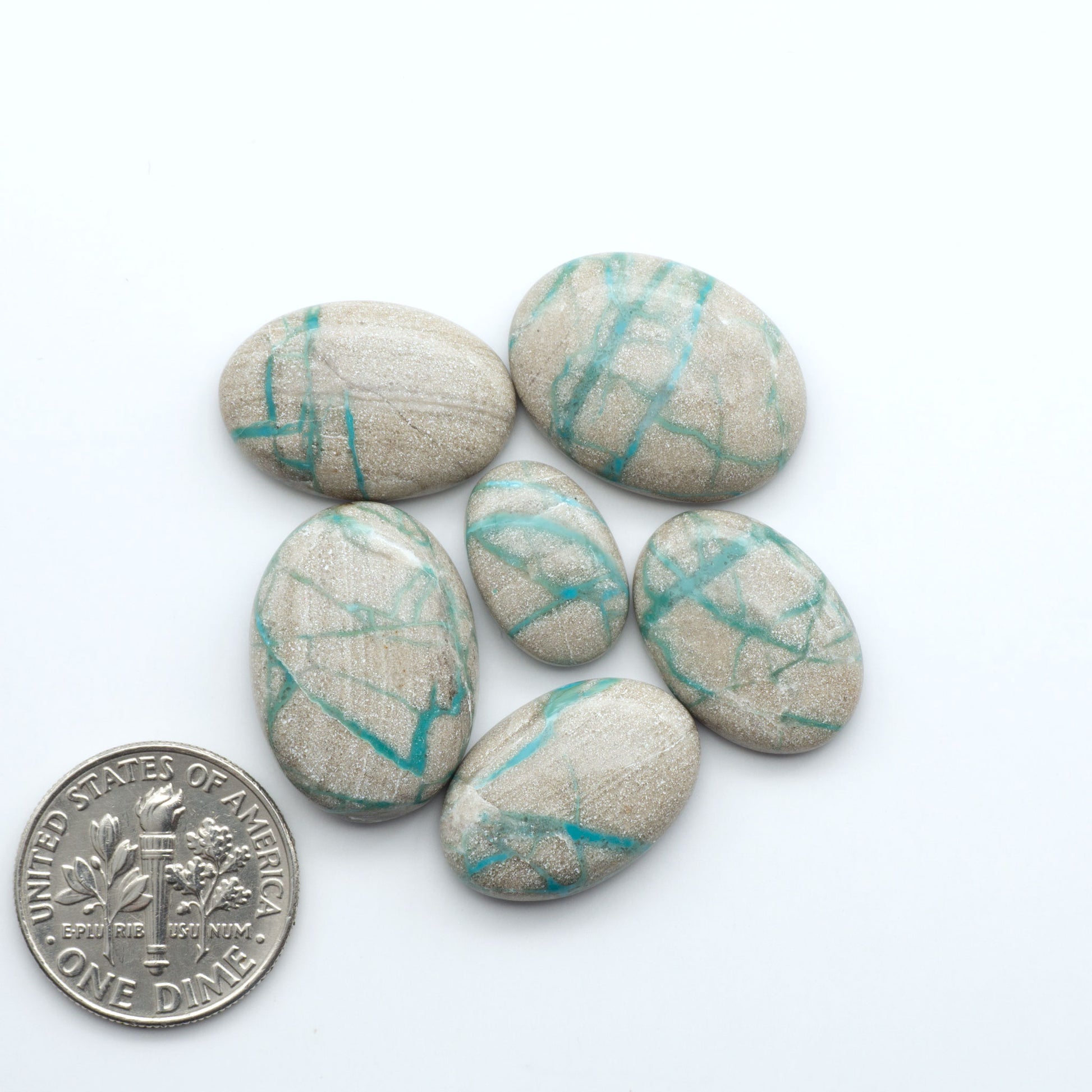 Carico Lake Turquoise cabochons with vibrant aqua-blue to turquoise tones and natural matrix, ideal for rings, pendants, and artisan jewelry.