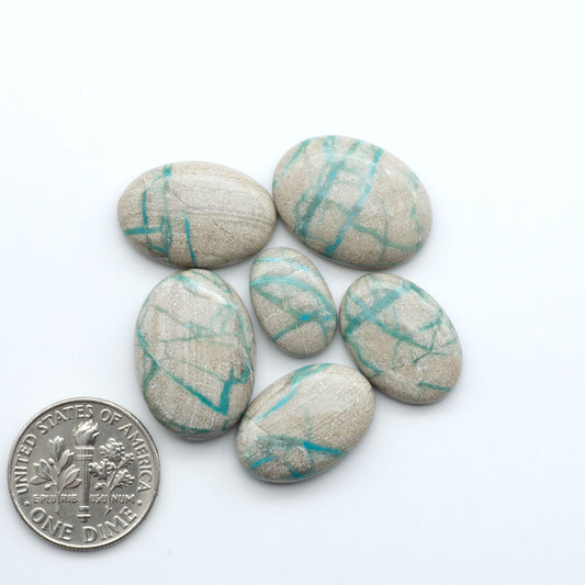 Carico Lake Turquoise cabochons with vibrant aqua-blue to turquoise tones and natural matrix, ideal for rings, pendants, and artisan jewelry.