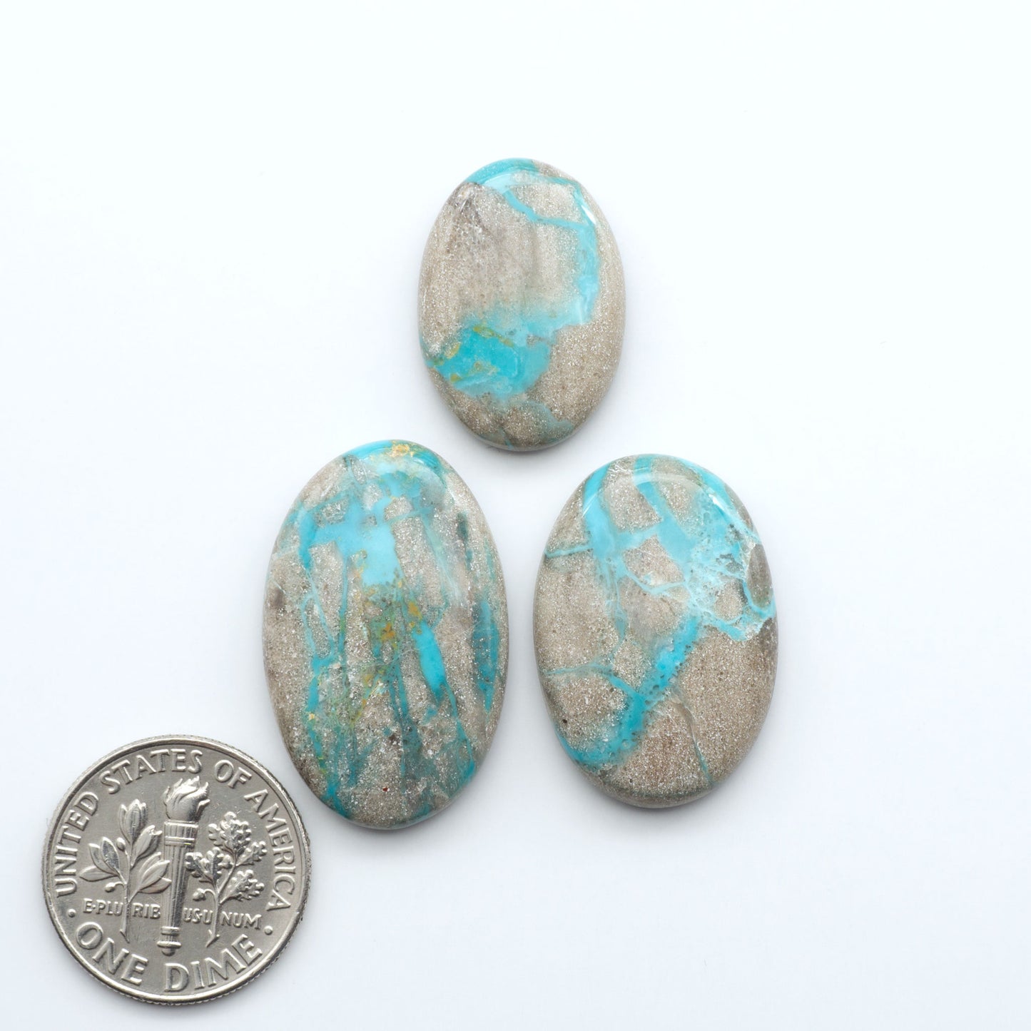 Carico Lake Turquoise cabochons with vibrant aqua-blue to turquoise tones and natural matrix, ideal for rings, pendants, and artisan jewelry.