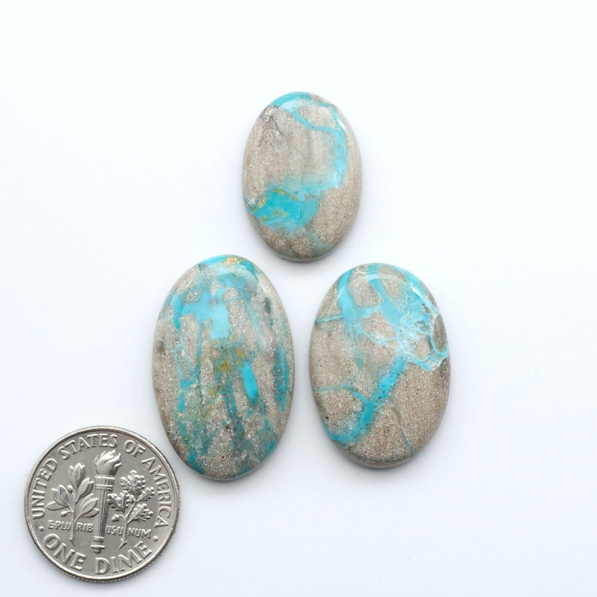 Carico Lake Turquoise cabochons with vibrant aqua-blue to turquoise tones and natural matrix, ideal for rings, pendants, and artisan jewelry.