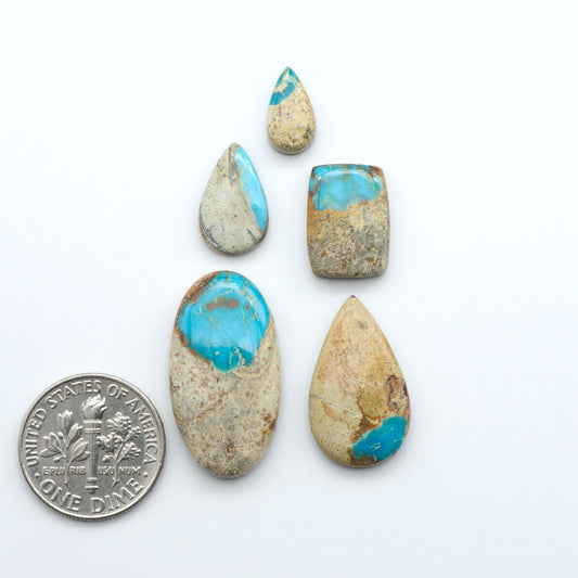 Royston Turquoise cabochons are famous for their distinctive matrix and unique green and blue hues, making them a favored option among jewelry designers.