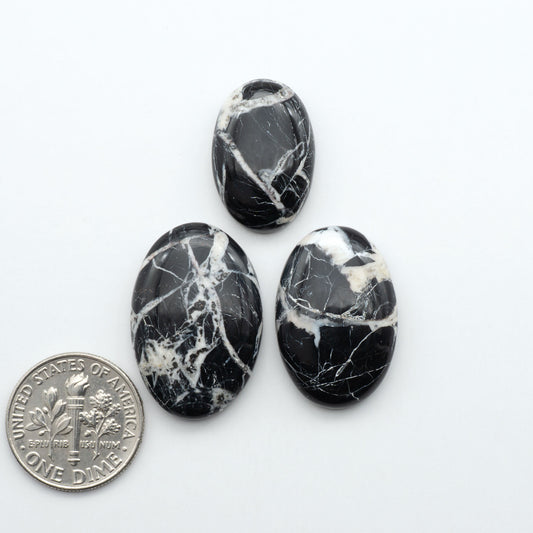 Natural White Buffalo Stone Cabochons are semi-precious gemstones cut into shapes ideal for jewelry-making, making them an excellent choice for artisans.