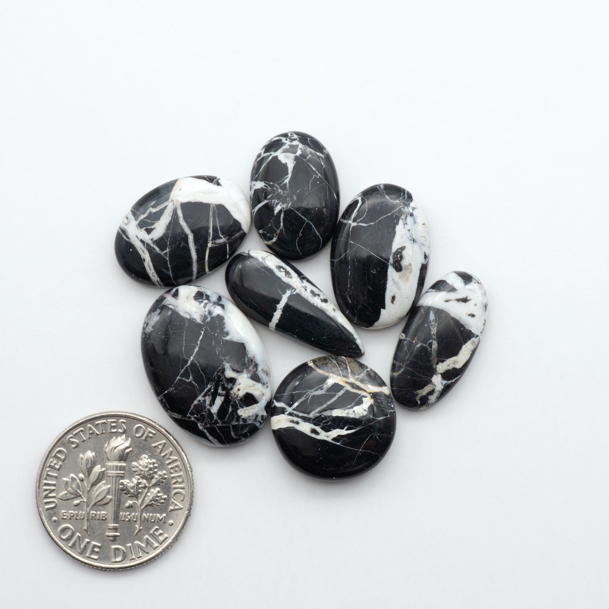 Natural White Buffalo Stone Cabochons are semi-precious gemstones cut into shapes ideal for jewelry-making, making them an excellent choice for artisans.