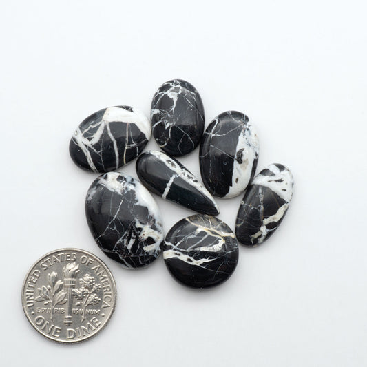 Natural White Buffalo Stone Cabochons are semi-precious gemstones cut into shapes ideal for jewelry-making, making them an excellent choice for artisans.