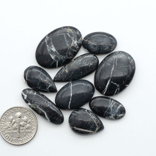 Natural White Buffalo Stone Cabochons are semi-precious gemstones cut into shapes ideal for jewelry-making, making them an excellent choice for artisans.