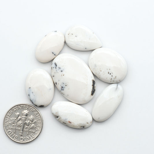 Natural White Buffalo Stone Cabochons are semi-precious gemstones cut into shapes ideal for jewelry-making, making them an excellent choice for artisans.