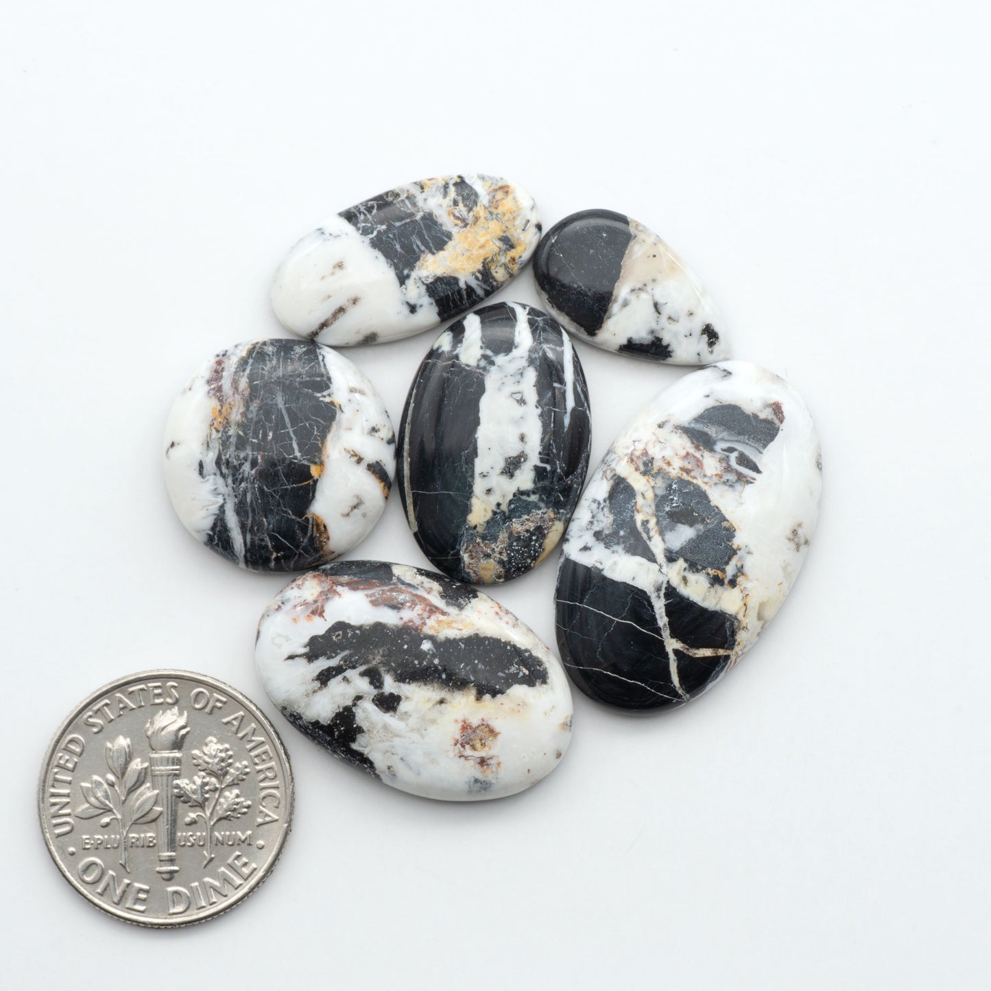 Natural White Buffalo Stone Cabochons are semi-precious gemstones cut into shapes ideal for jewelry-making, making them an excellent choice for artisans.