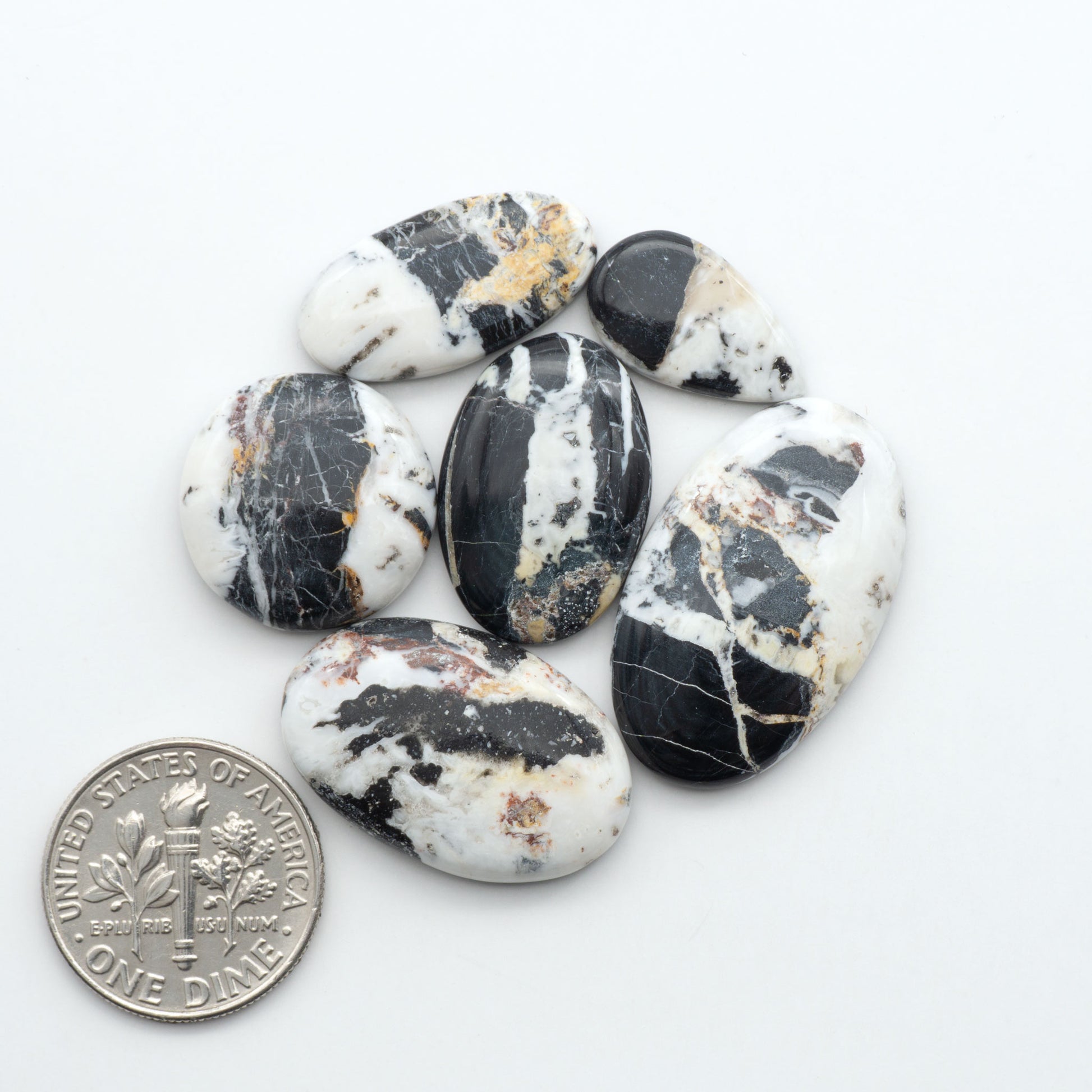 Natural White Buffalo Stone Cabochons are semi-precious gemstones cut into shapes ideal for jewelry-making, making them an excellent choice for artisans.