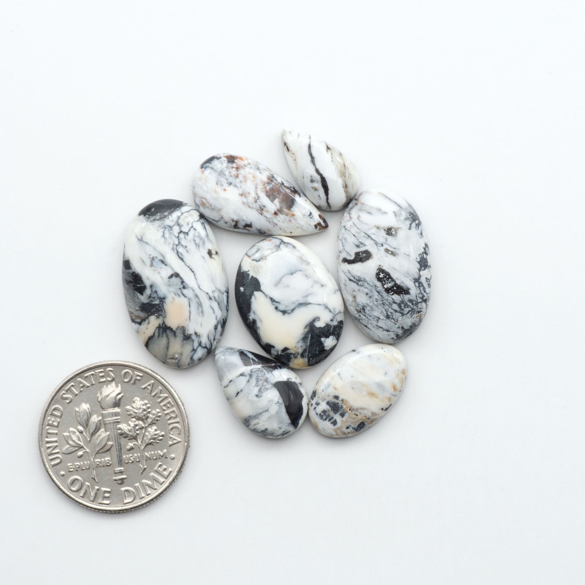 Natural White Buffalo Stone Cabochons are semi-precious gemstones cut into shapes ideal for jewelry-making, making them an excellent choice for artisans.