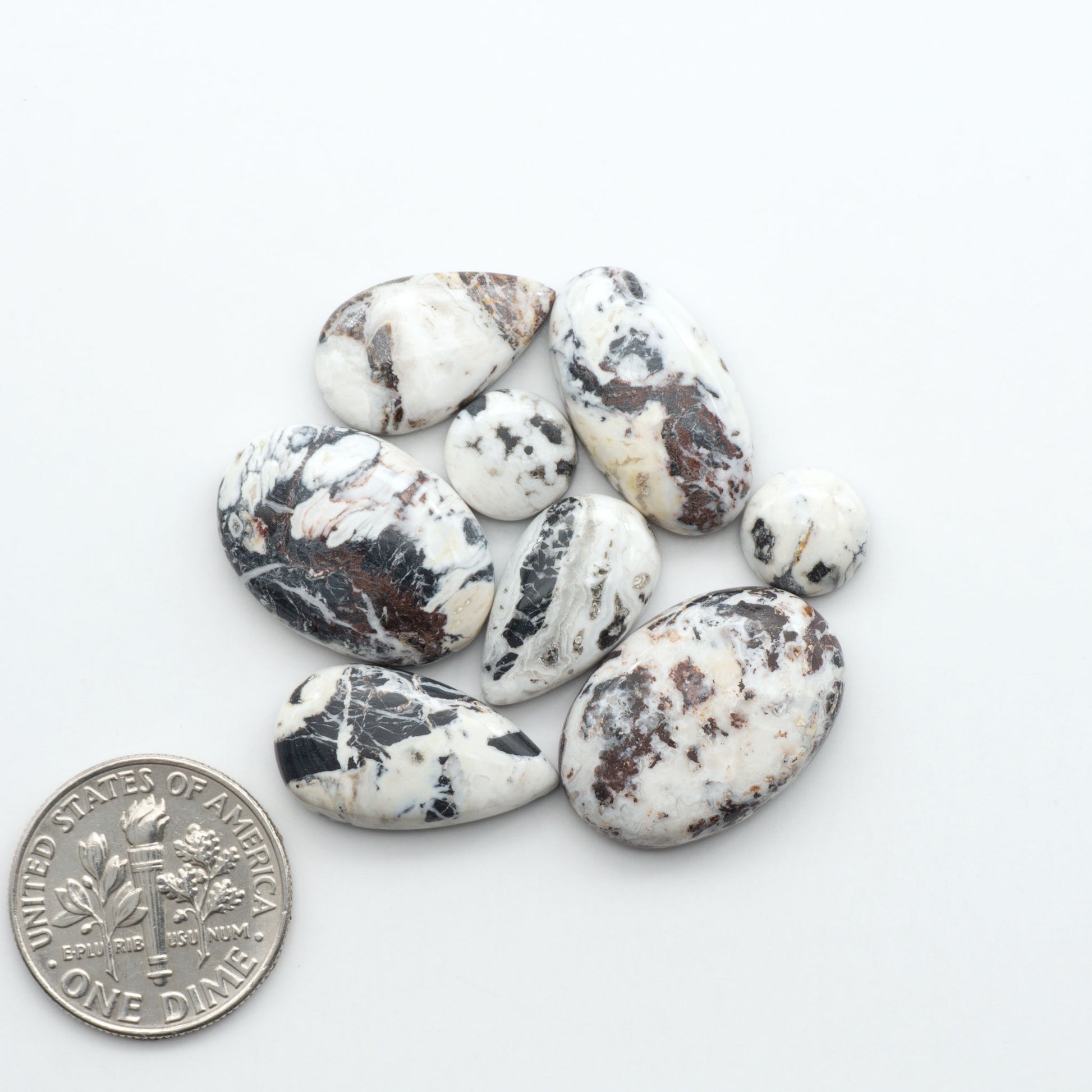 Natural White Buffalo Stone Cabochons are semi-precious gemstones cut into shapes ideal for jewelry-making, making them an excellent choice for artisans.