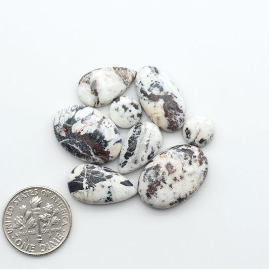 Natural White Buffalo Stone Cabochons are semi-precious gemstones cut into shapes ideal for jewelry-making, making them an excellent choice for artisans.