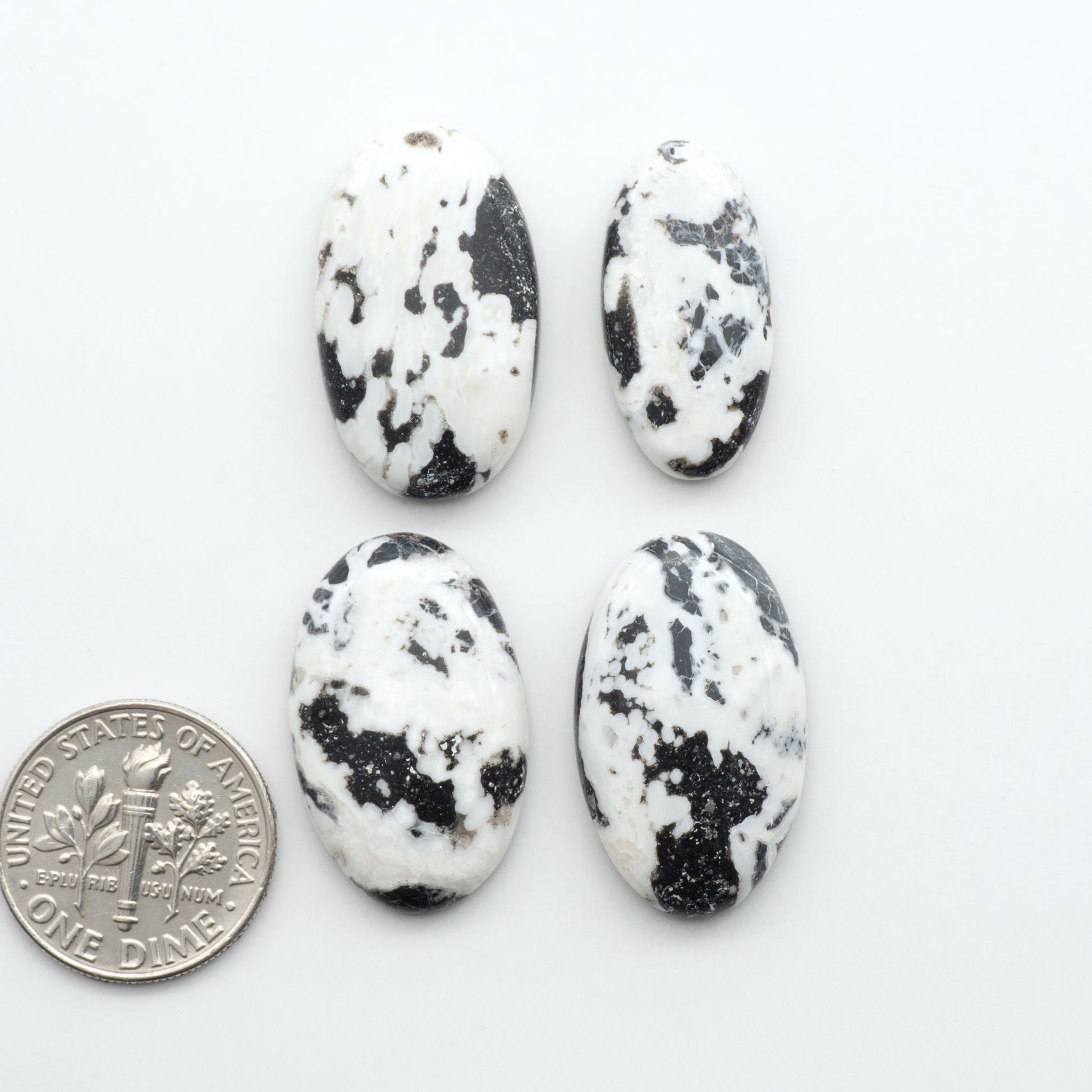 Natural White Buffalo Stone Cabochons are semi-precious gemstones cut into shapes ideal for jewelry-making, making them an excellent choice for artisans.