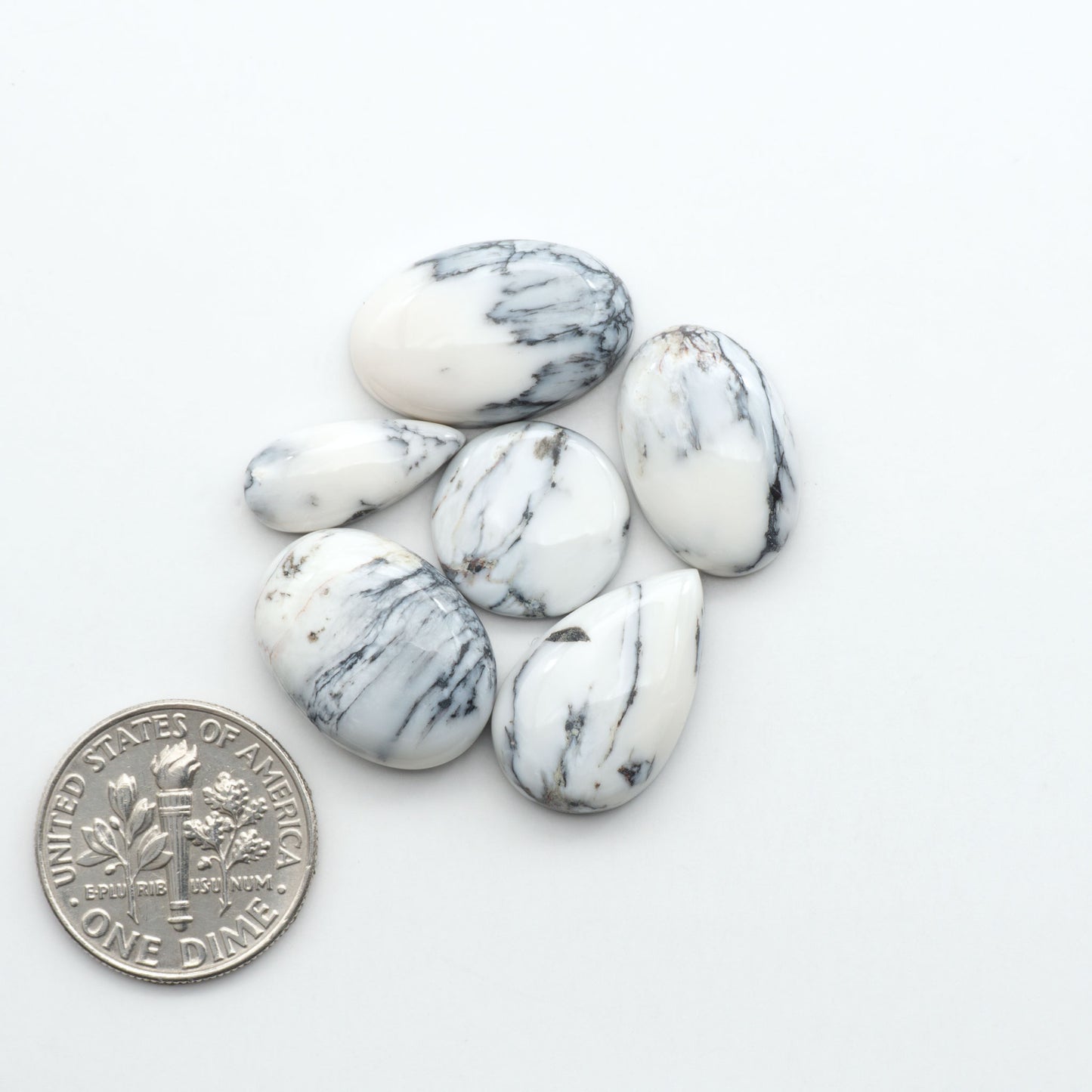 Natural White Buffalo Stone Cabochons are semi-precious gemstones cut into shapes ideal for jewelry-making, making them an excellent choice for artisans.